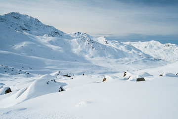 Fototapeta na wymiar Panoramic view across snow covered alpine mountain range