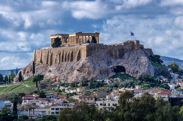 The Acropolis of Athens city in Greece with the Parthenon Temple (dedicated to goddess Athena) as seen from the Panathenaic Stadium (Kallimarmaro). Scenic view. Sunny day with blue cloudy sky