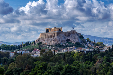 The Acropolis of Athens city in Greece with the Parthenon Temple (dedicated to goddess Athena) as seen from the Panathenaic Stadium (kallimarmaro). Scenic view. Sunny day with blue cloudy sky
