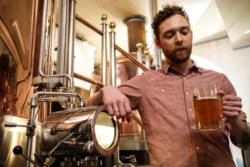 Man tasting fresh beer in a brewery