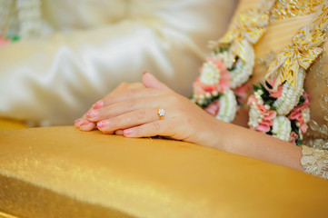 hands of a wedding couple, Groom put a ring on finger of his lovely wife, wedding ceremony
