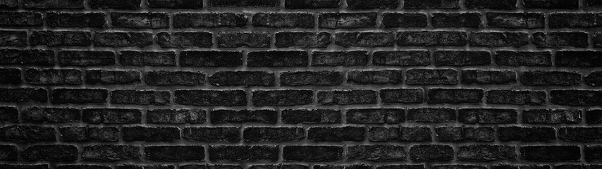 Wide black brick wall texture. Dark brickwork panoramic background