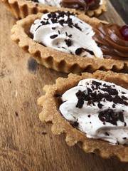 Delicious cakes with berry cream and chocolate