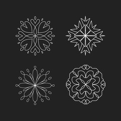 White abstract ornaments on black chalkboard