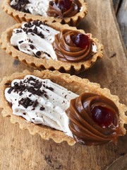 Delicious cakes with berry cream and chocolate