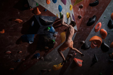 Athletic man practicing in a bouldering gym © Nejron Photo