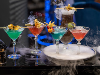 cocktails in glass cups on a tray