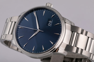 Mens silver watch with a blue dial, silver clockwise, chronograph, with a steel strap isolated on white background