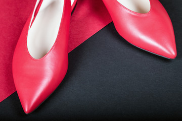 women's classic red shoes on red black background - Powered by Adobe