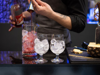 the bartender mixes a cocktail
