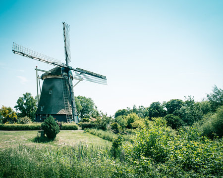 old Dutch windmill, Amsterdam De Riekermolen, Amstelpark, Amstel River