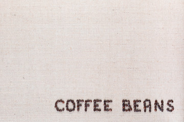 Fototapeta na wymiar Coffee beans inscription from seeds arranged bottom right