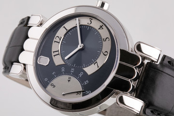 Female silver watch with a black dial, silver clockwise, stopwatch with a black leather strap. 