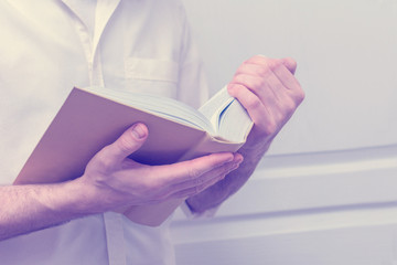 Men reading a book, concept education, toned, sunlight effects, close up