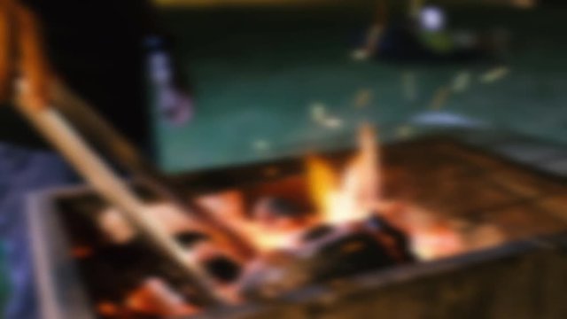 Blur glowing barbecue embers, fire charcoal in the stove for cooking and grilling food or outdoor barbecue. Royalty high-quality free blurry stock footage of embers burning with red and yellow flame 