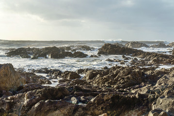 Fototapeta na wymiar Waves hitting the shore at a beach in Porto