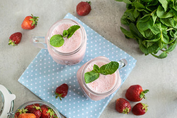 Healthy dessert concept. Fresh organic sugar free strawberry smoothie or milkshake with mint top view.