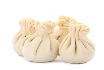 Heap of raw dumplings with tasty filling on white background