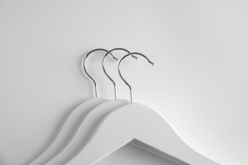 Empty clothes hangers on white background, top view