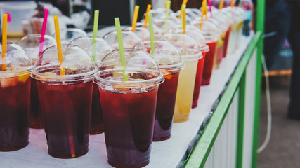 Street food and drinks. Fresh fruit cocktail in a plastic glass