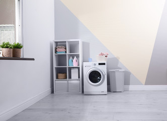 Modern washing machine in laundry room interior. Space for design