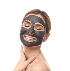 Beautiful woman with black mask on face against white background
