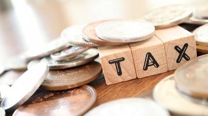 Text Block of "Cost" and Japanese Yen Coins on Table