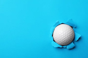 Foto op Aluminium New golf ball stuck in color paper. Space for text © New Africa