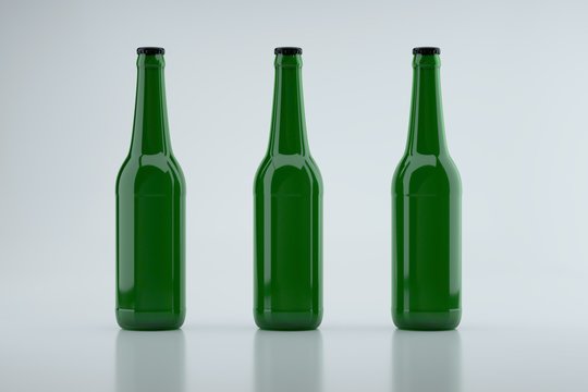 Three green glass beer bottles. Image to insert label.
