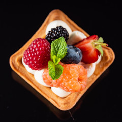 Fresh Fruit Tart with berries isolated on black background