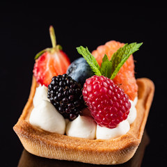 Fresh Fruit Tart with berries isolated on black background