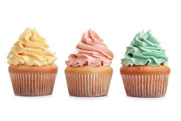 Delicious cupcakes with cream on white background