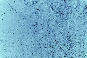 Vintage blue background. Rough painted wall of sapphire color. Imperfect plane of blue colored. Uneven old decorative toned backdrop of cyan tint. Texture of sapphirine hue. Ornamental stony surface.