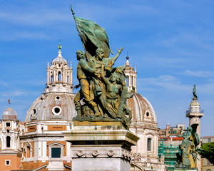 Fototapeta na wymiar Santa Maria church with statue in foreground in Rome, Italy with bright blue skies.