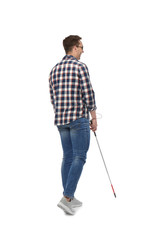 Young blind person with long cane walking on white background