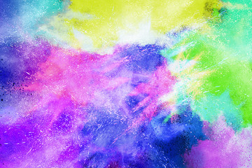 Fototapeta premium Freeze motion of colorful color powder exploding on white background. Paint Holi.