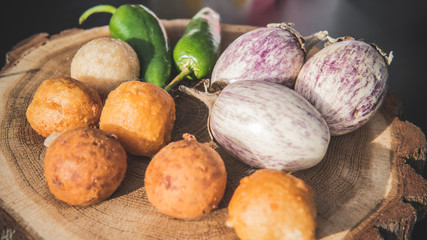 Fried cheese balls with onion and hot peppers close-up. Street food.