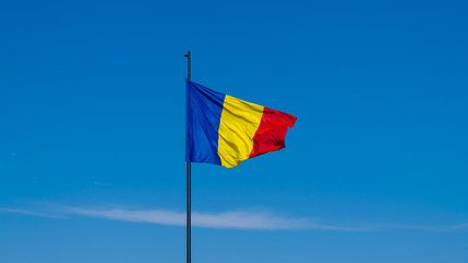 Romanian flag waving on a sunny summer day in Alba Iulia, Romania