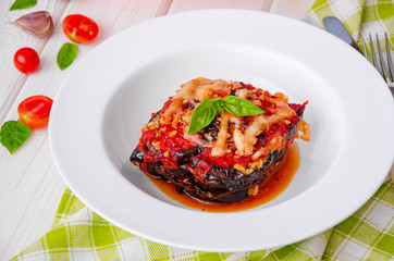Eggplant casserole with tomato sauce, cheese and fresh basil. Delicious summer stew.