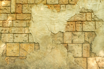 View of the old wall from  coquina and fallen-off  plaster. Stylized textured grunge background