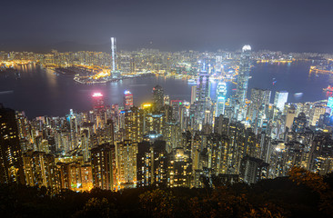 Glowing skyscrapers along Victoria Harbour in Hong Kong at night