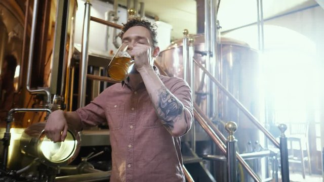 Man tasting fresh beer in a brewery