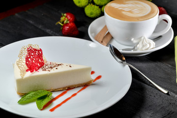 cake with strawberries and cup of coffee