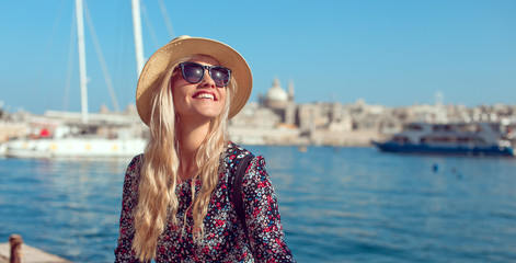 Happy blonde tourist lady enjoying mediterranean city at sea - obrazy, fototapety, plakaty
