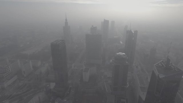 Aerial view. Flying in a foggy morning in the direction of the skyscrapers in the center of Warsaw.