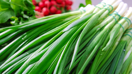 Green onions, bunches tied. Oriental Bazaar, parsley, pepper garlic hot sauce radish.