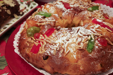 Close-up of a Bolo-rei in a decorative red platter. A traditional Portuguese cake usually eaten around Christmas.