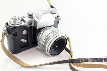 Old camera in a leather case on a white background. Mechanical retro camera silver.