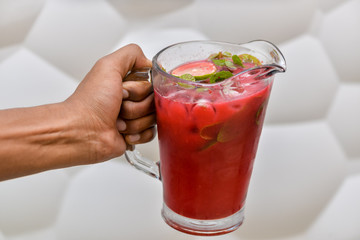 strawberry lemonade with ice in hand