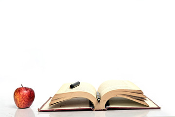Book and red apple isolated on white